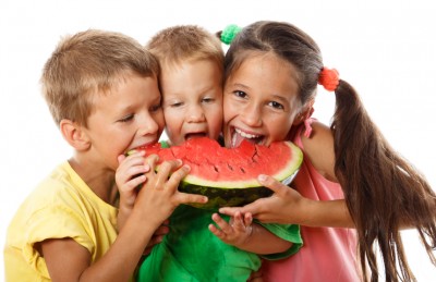 Happy family eating watermelon