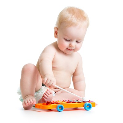 Funny Child Playing  With Musical Toys. Isolated On White Backgr