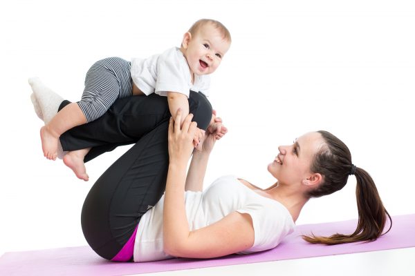 Mother With Baby Doing Gymnastics And Fitness Exercises